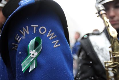A Newtown High School band member wears a green ribbon in honor of Sandy Hook victims.