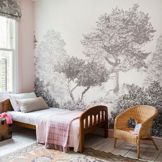 bedroom with wooden floor and arm chair and wallpaper wall