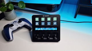 A photo of the Stream Deck + facing the camera on a white desk with colourful lighting