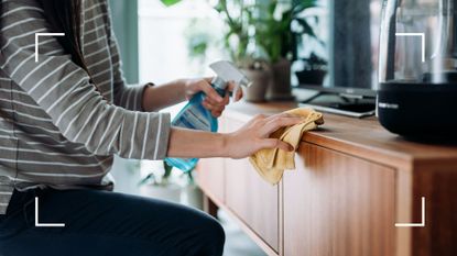 picture of woman wiping down a surface in the home with cloth