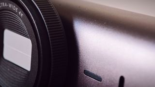 A Graphite-coloured Logitech MX Brio webcam sitting on top of a monitor