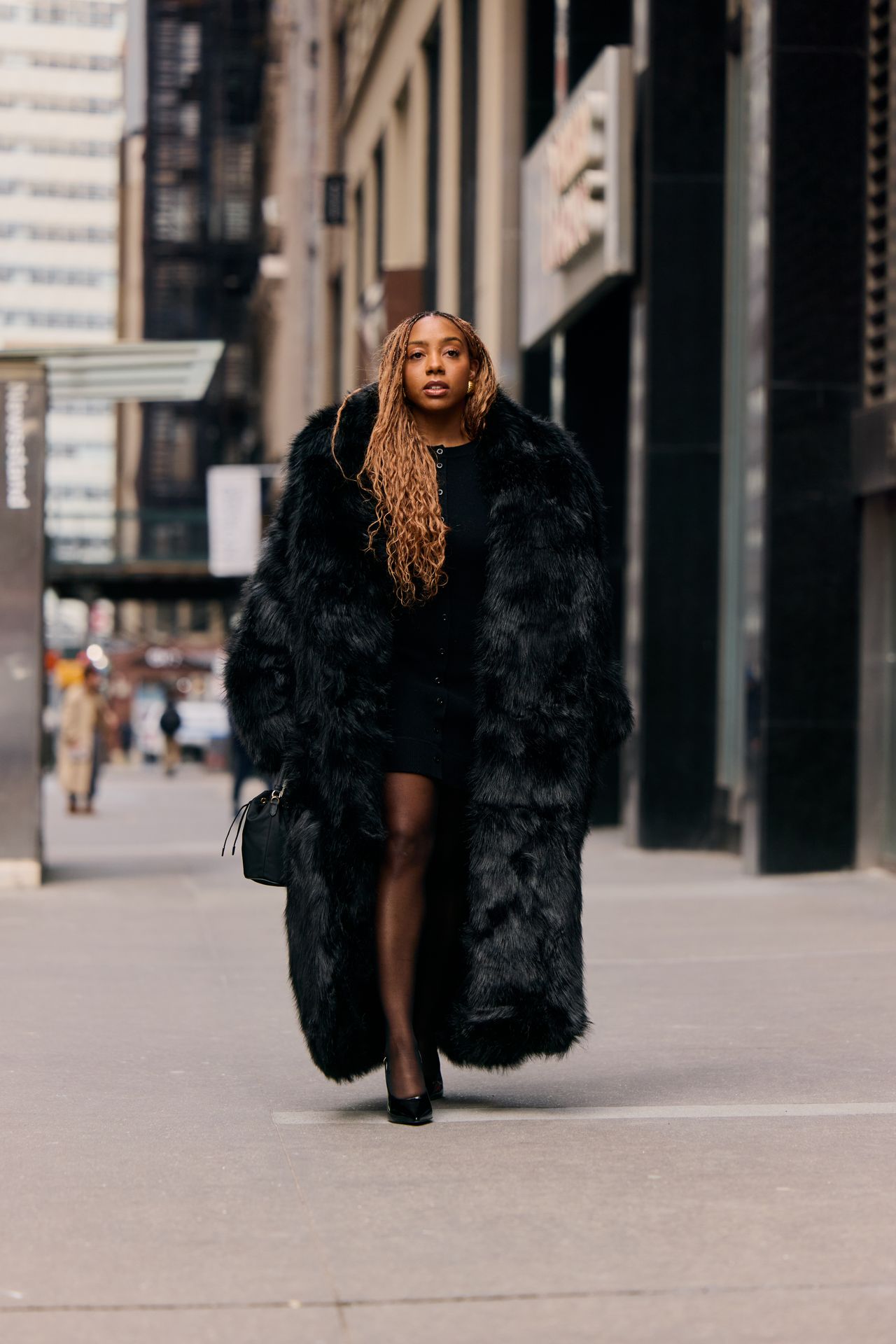 Lindsay Peoples wearing a black long fur coat during F/W 25 fashion week in New York.