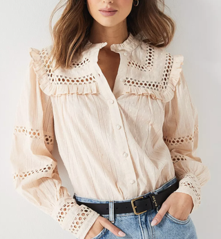 Image of woman wearing beige blouse