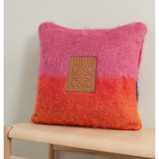 orange and pink loewe pillow with leather logo at the centre