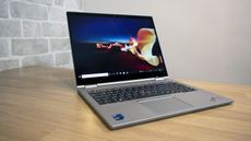 A photograph of the Lenovo ThinkPad X1 Titanium Yoga on a table
