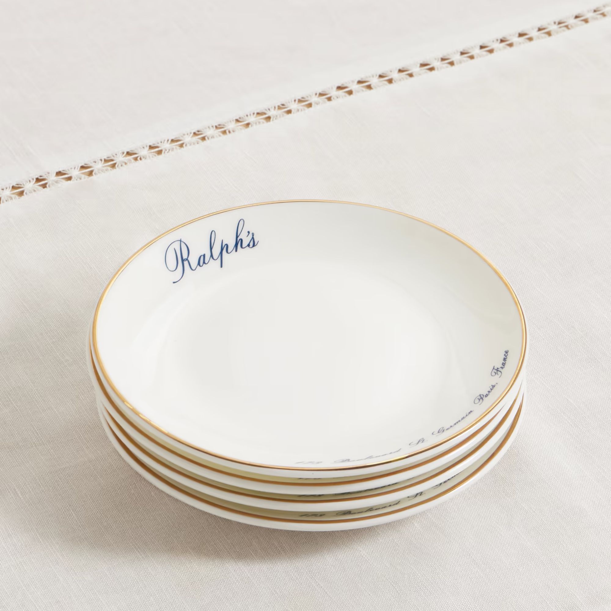 Ralph Lauren plates with small blue 'Ralph's' wording on a cream plate