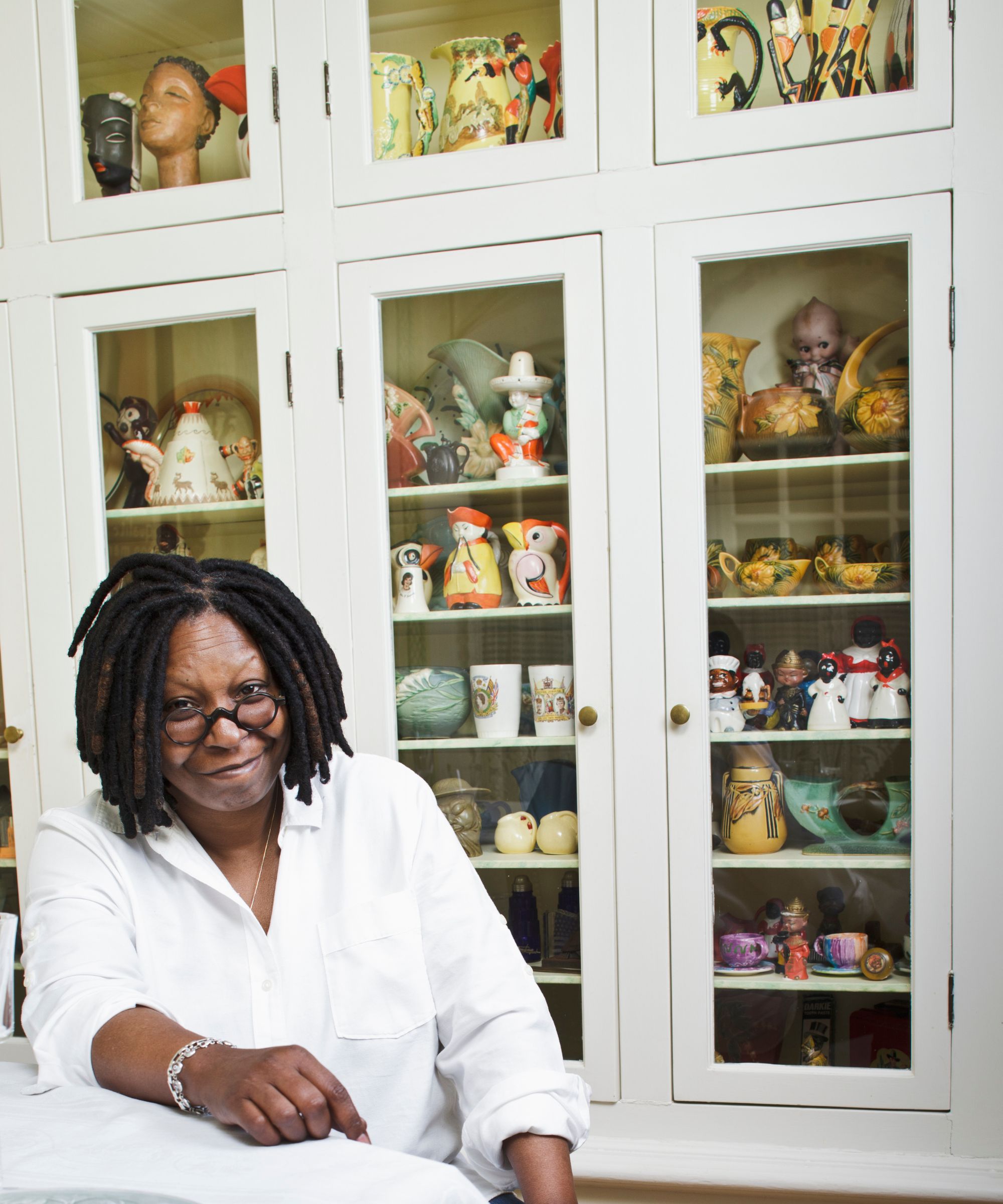 whoopi goldberg in front of her ceramics collection