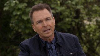 Phil Keoghan gives an interview in a suit while talking about The Amazing Race.