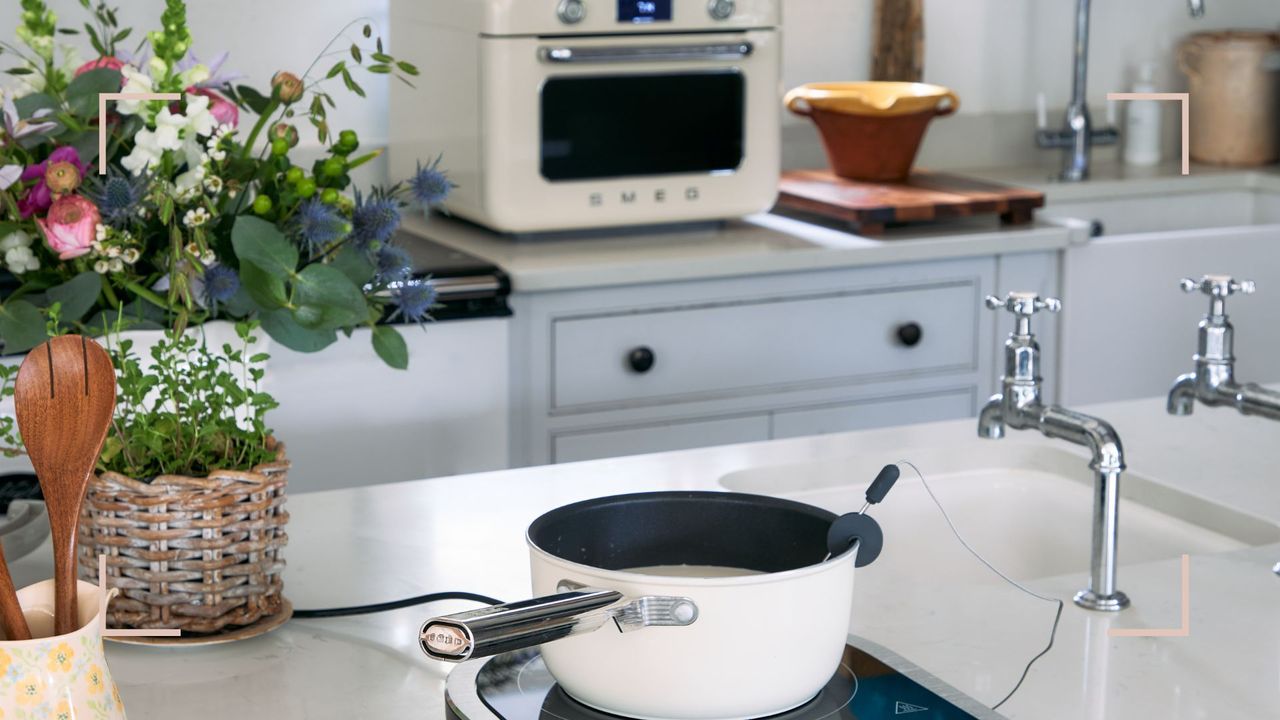 country kitchen with new Smeg portable induction cooker on white marble countertop with countertops oven in the background