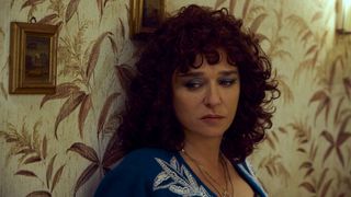 Vittoria (Valeria Golino) leans against a wall in The Lying Life of Adults
