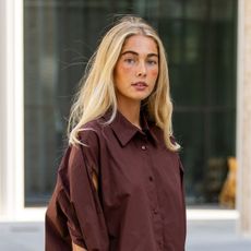 woman with blonde hair wearing brown button up shirt