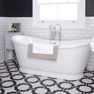 bathroom with vinyl floor tiles and bathtub