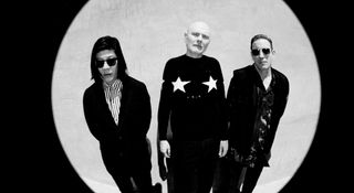 A fish-eye black-and-white portrait of Smashing Pumpkins' James Iha, Billy Corgan and Jimmy Chamberlin.