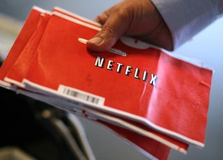 A U.S. Postal worker holds a stack of Netflix envelopes at the U.S. Post Office sort facility on October 24, 2011 in San Francisco, California.