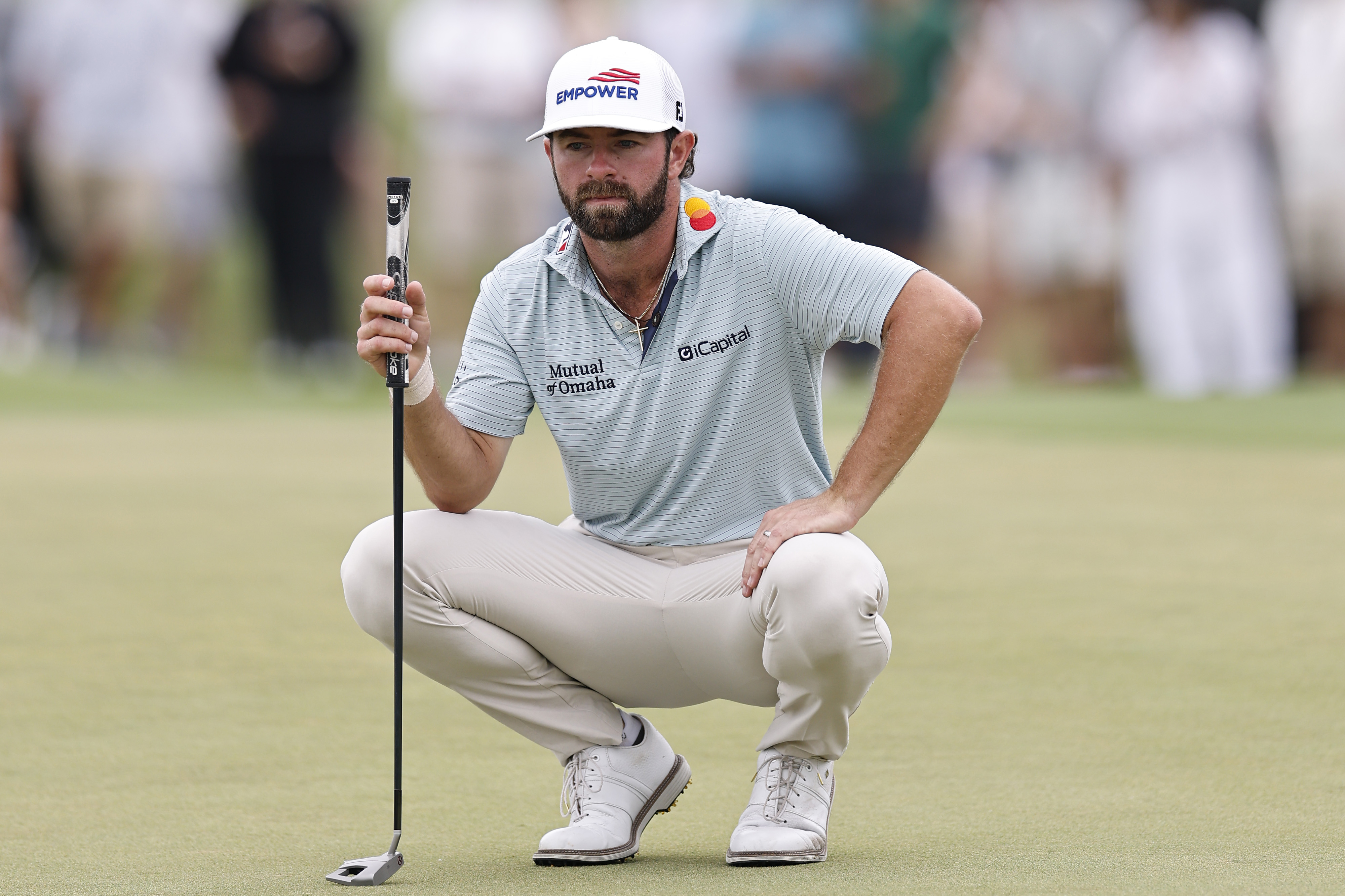 Cameron Young lines up a putt on the third green during the final round of the Cadillac Championship