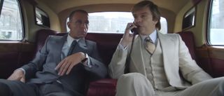 Jeremy Strong watches Sebastian Stan take a phone call in the backseat of a limo in The Apprentice.