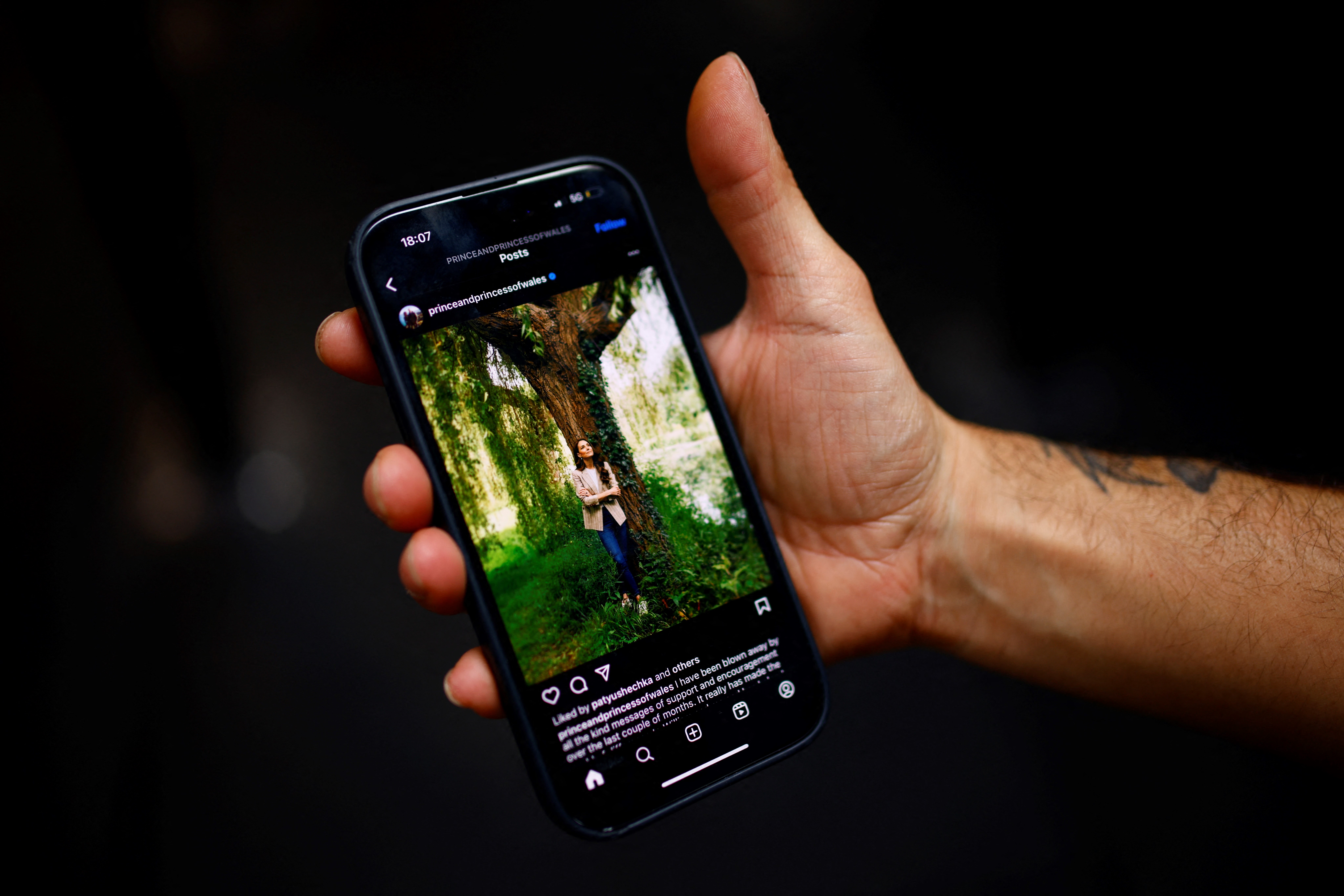A man holds a mobile phone showing on a social media post by Britain's Catherine, Princess of Wales, in London, on June 14, 2024. Catherine, Princess of Wales will attend the Trooping the Colour military parade this weekend, she said in a social media post on Friday, confirming her first public appearance since December.