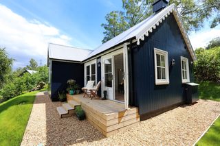 bungalow with navy cladding and white roof