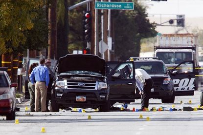 Investigators examine a vehicle involved in the San Bernardino shooting.