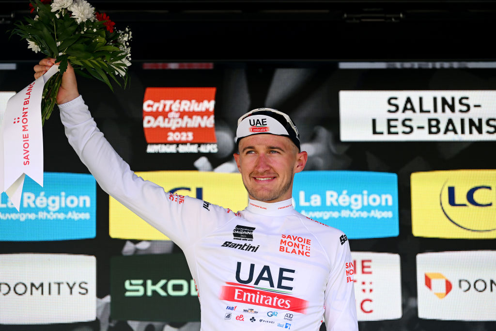 SALINSLESBAINS JUNE 08 Mikkel Bjerg of Denmark and UAE Team Emirates celebrates at podium as White best young jersey winner during the 75th Criterium du Dauphine 2023 Stage 5 a 1911km stage from CormoranchesurSane to SalinslesBains UCIWT on June 08 2023 in SalinslesBains France Photo by Dario BelingheriGetty Images