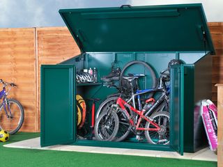 Asgard bike storage shed is pictured with bikes inside and is a way of ensuring that you are covered by the best bicycle insurance