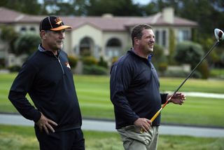 Harris Barton stands and watches during the Pebble Beach event