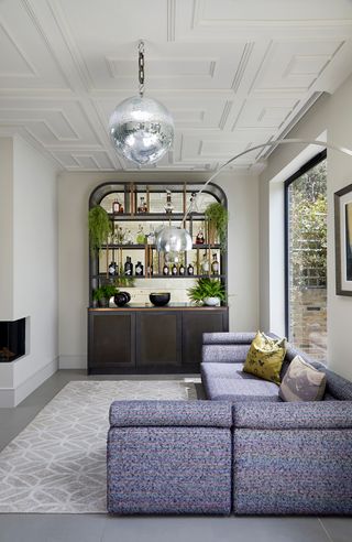 Snug with a home bar by Hux London joinery