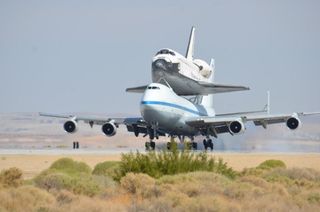 NASA's Space shuttle Endeavour, riding piggyback atop a Shuttle Carrier Aircraft, lands at NASA's Dryden Flight Research Facility in Southern California on Sept. 20, 2012, during the final shuttle ferry flight.
