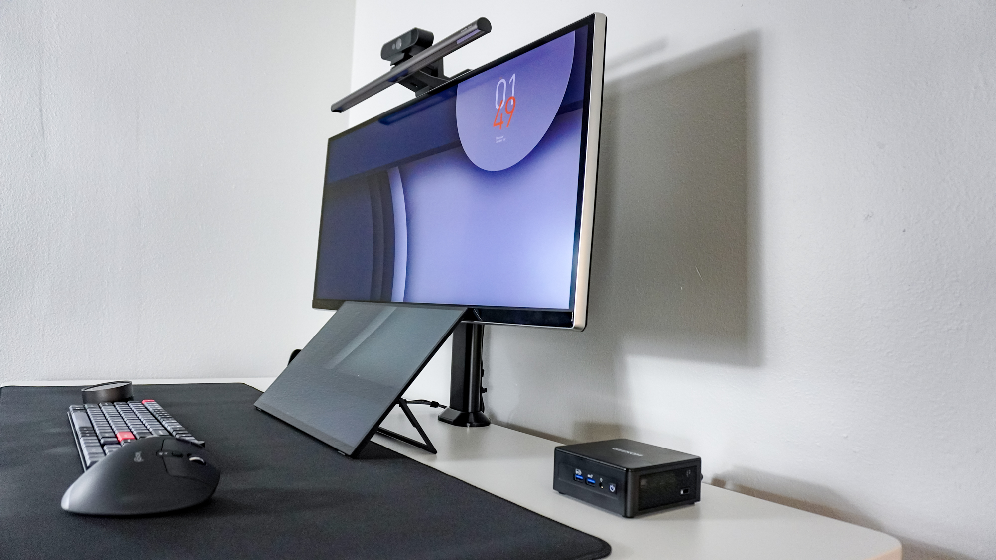 A side view of the Geekom IT15 mini PC on the Hexcal Elevate standing desk