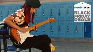 Girl playing a Fender Stratocaster guitar