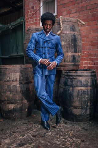 Ncuti Gatwa wears a blue pinstripe suit in a promotional image for the new series of Doctor Who