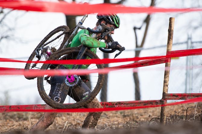 Gage Hecht shoulders his bike