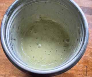 A smooth and creamy green smoothie in the nutribullet Flip™ Insulated Portable Blender