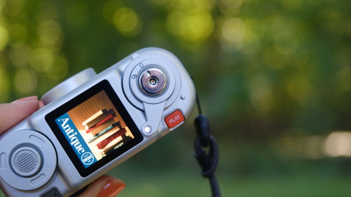 The Instax Pal 2 in a photographer's hands