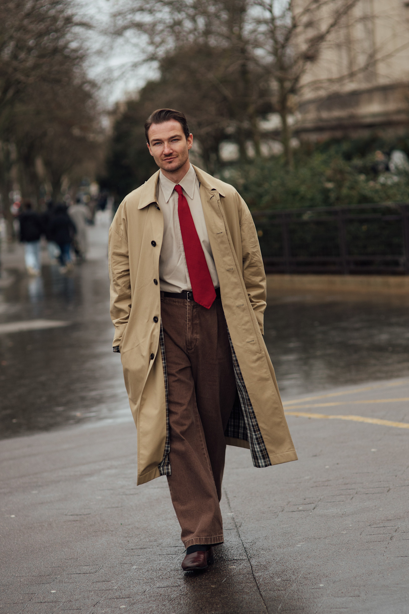 a man wearing a red tie in mens fashion week street style