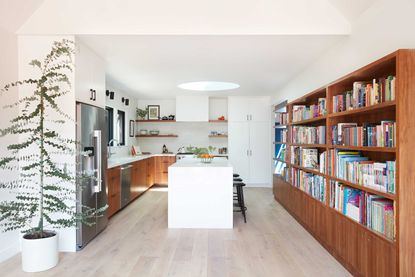a kitchen with a large bookcase