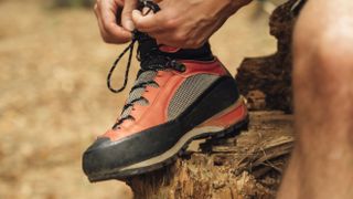 Person tying laces on hiking shoe