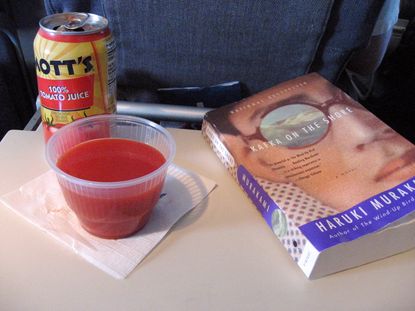 A cold glass of tomato juice during a flight