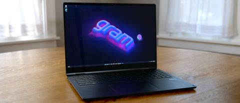 LG Gram Pro 16 2-in-1 (16T90SP) open on a wooden table showing &quot;gram&quot; logo on the screen