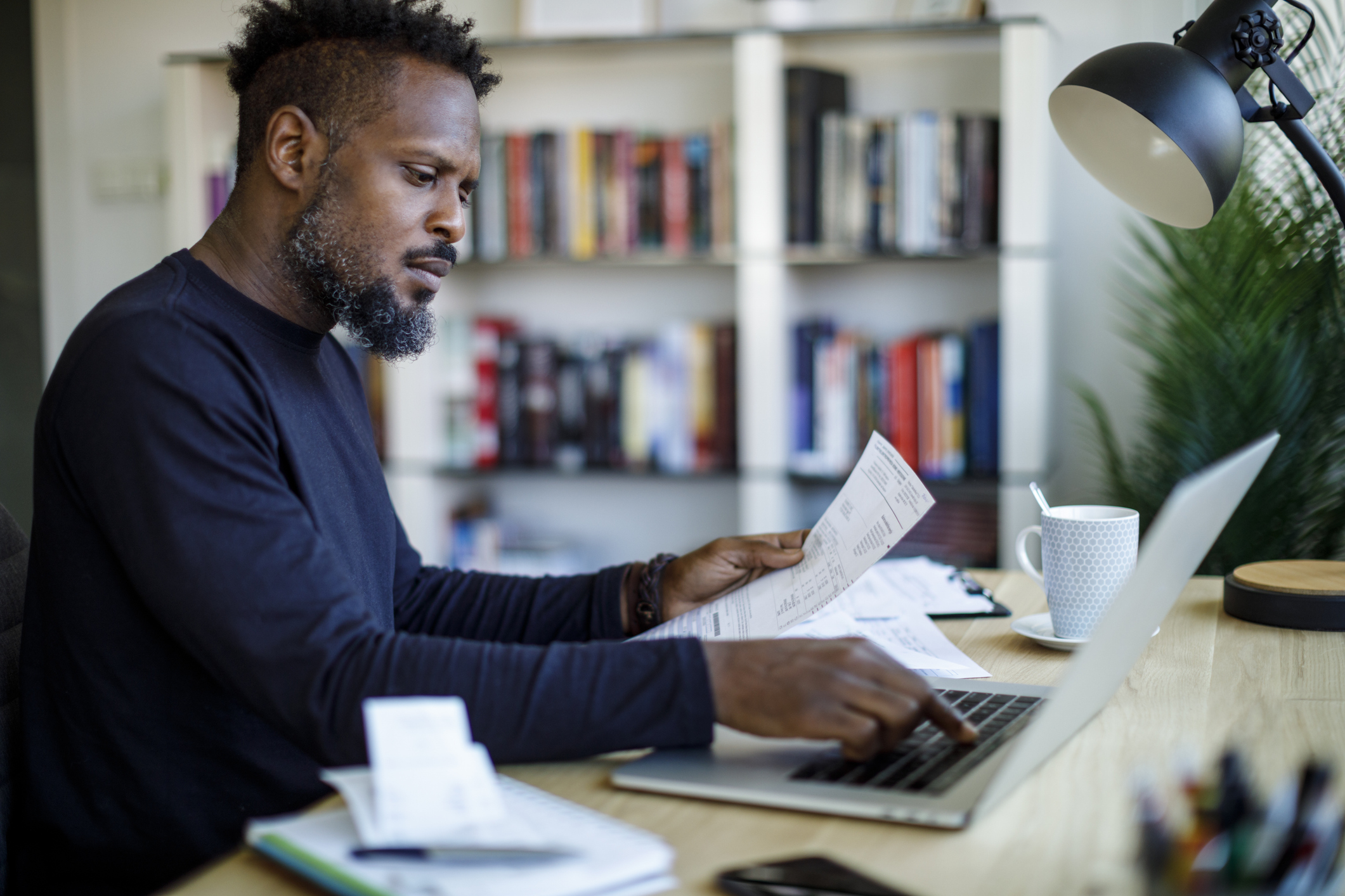 Man organising savings and investing documents
