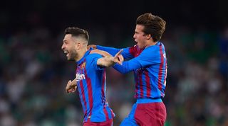 Jordi Alba and Riqui Puig celebrate a late win for Barcelona against Real Betis.