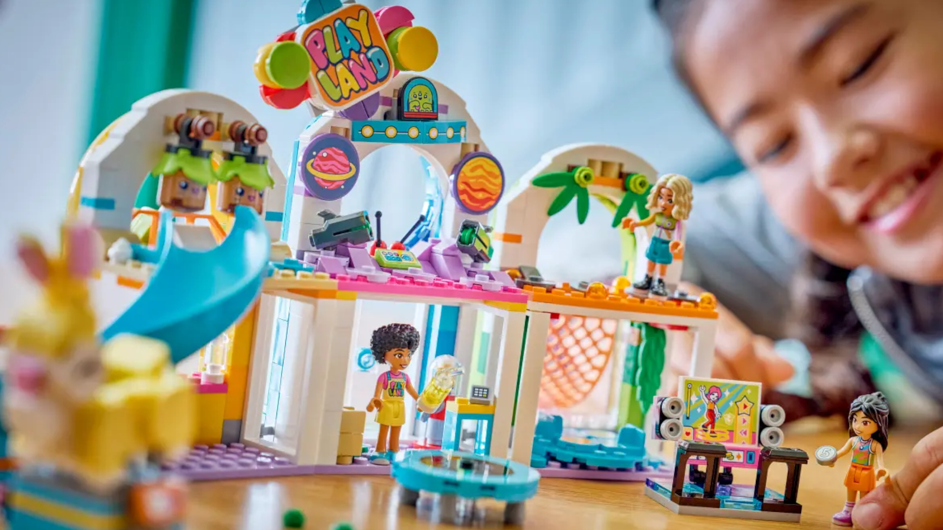 A child plays with a Lego playground set