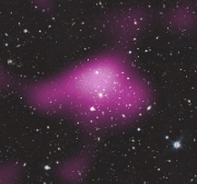 A gif of a deep space image with a purple blob of light appearing on top of the image and then disappearing showing a dark matter heat map of sorts.