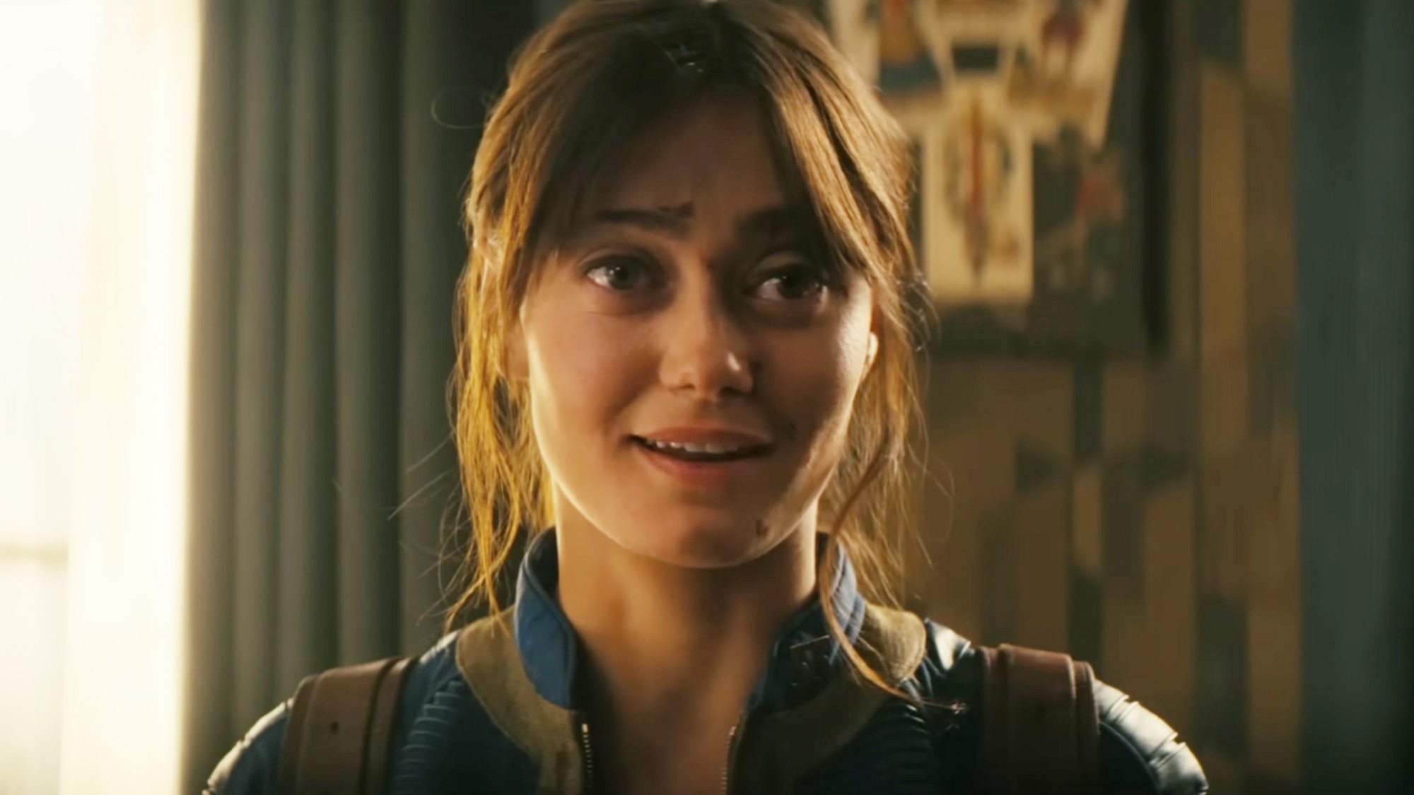 Lucy smiling in response to a question. 