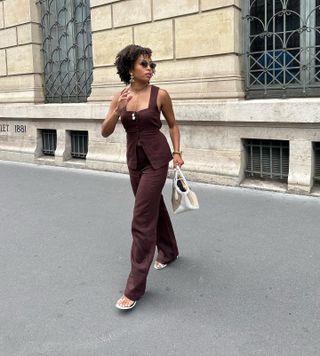 French woman wearing a brown outfit