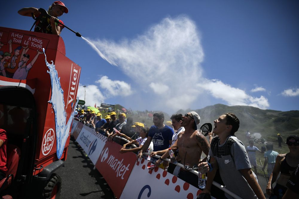 A water cannon cools down spectators as temperatures soar