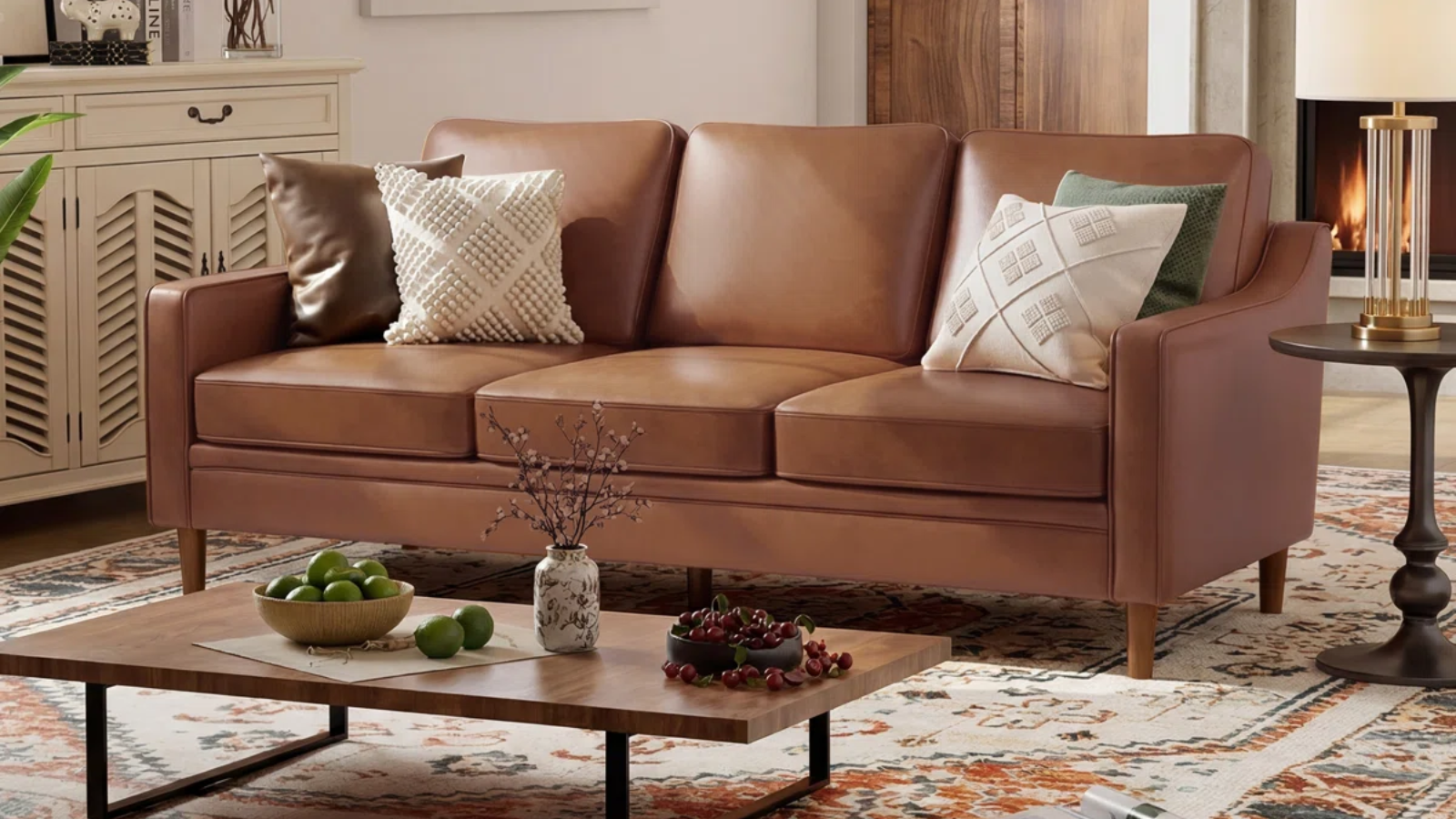 a large tan couch in a living room with a small coffee table with decor on it