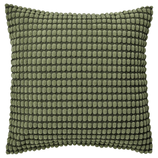 A textured dark green cushion