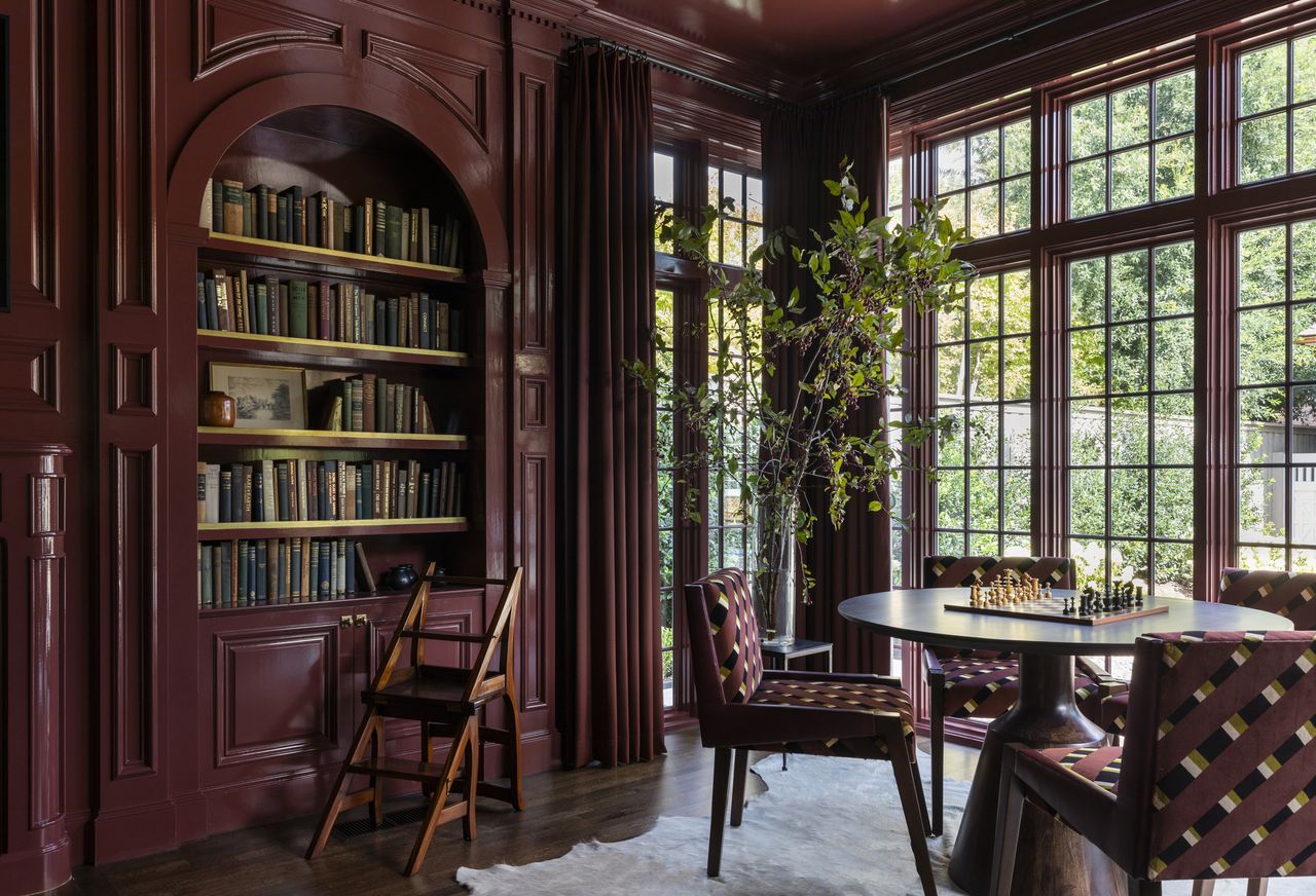 A home library color drenched in burgundy