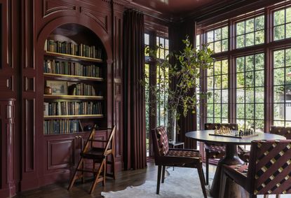 A home library color drenched in burgundy